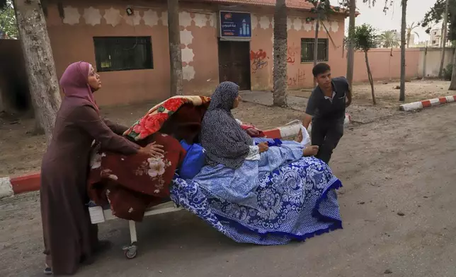 Palestinians evacuate patients from the European hospital in Khan Younis, Gaza, after it was hit by an Israeli army airstrike, Tuesday, May 13, 2025. The Israeli military said it had carried out a strike targeting what it said was a Hamas "command and control center" located beneath the hospital. (AP Photo/Mariam Dagga)
