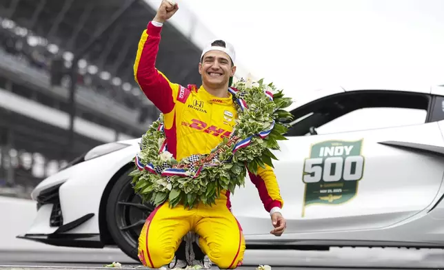 Alex Palou, of Spain, celebrates on the Yard of Bricks on the start/finish line after winning the Indianapolis 500 auto race at Indianapolis Motor Speedway in Indianapolis, Sunday, May 25, 2025. (AP Photo/AJ Mast)