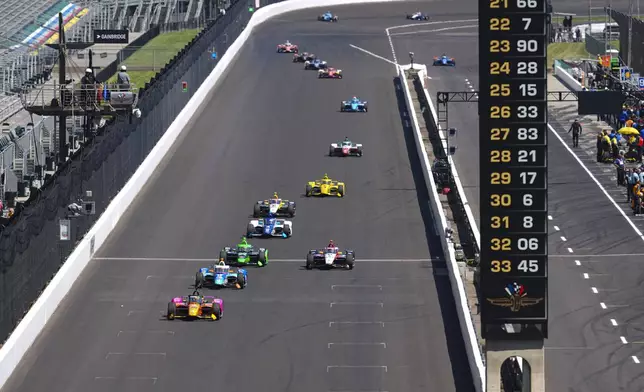 Devlin DeFrancesco, of Canada, leads a pack of cars during practice for the Indianapolis 500 auto race at Indianapolis Motor Speedway in Indianapolis, Friday, May 23, 2025. (AP Photo/Michael Conroy)