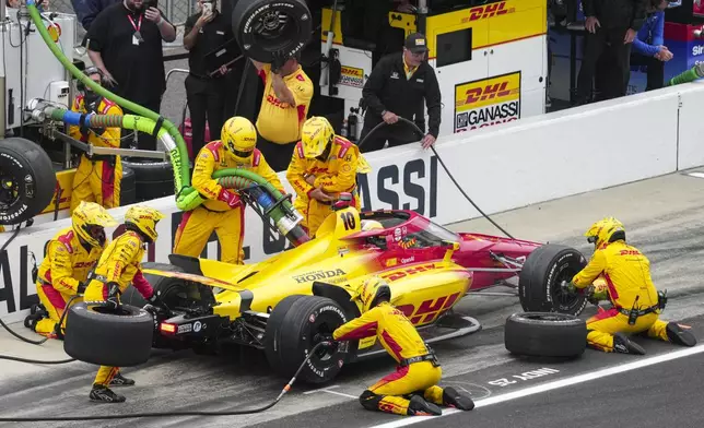 Alex Palou, of Spain, makes a pit stop during of the Indianapolis 500 auto race at Indianapolis Motor Speedway in Indianapolis, Sunday, May 25, 2025. (AP Photo/AJ Mast)