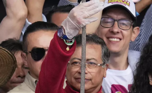 President Gustavo Petro holds a sword that once belonged to independence hero Simón Bolívar during a speech to supporters outside Congress in Bogotá, Colombia, Thursday, May 1, 2025, before presenting a referendum proposal on his labor reform to the Senate following two failed attempts in the legislature. (AP Photo/Fernando Vergara)