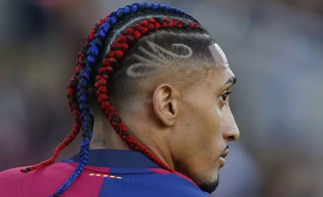 Barcelona's Raphinha challenges during the Spanish La Liga soccer match between Barcelona and Villarreal at Lluis Companys Olympic Stadium in Barcelona, Spain, Sunday, May 18, 2025. (AP Photo/Joan Monfort)