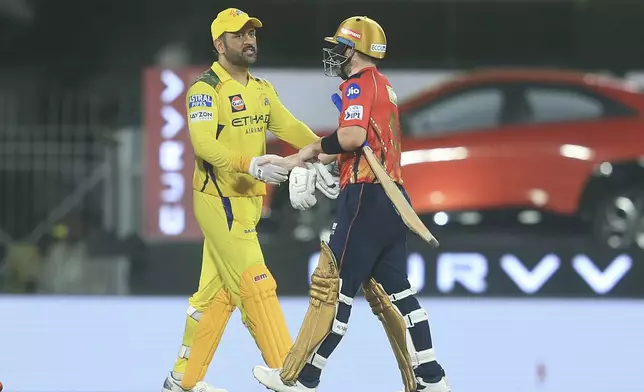 Punjab Kings' Josh Inglis, right, shake hand with Chennai Super Kings' Mahendra Singh Dhoni after they won during the Indian Premier League cricket match against them at M. A. Chidambaram Stadium in Chennai, India, Wednesday, April 30, 2025. (AP Photo/R. Parthibhan)