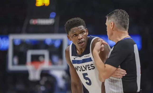 Minnesota Timberwolves guard Anthony Edwards (5) chats with referee Pat Fraher (26) during the first half of Game 2 of an NBA basketball Western Conference Finals playoff series against the Oklahoma City Thunder Thursday, May 22, 2025, in Oklahoma City. (AP Photo/Nate Billings)