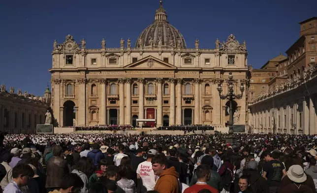 People wait before the funeral of Pope Francis in St. Peter's Square at the Vatican, Saturday, April 26, 2025. (AP Photo/Andreea Alexandru)