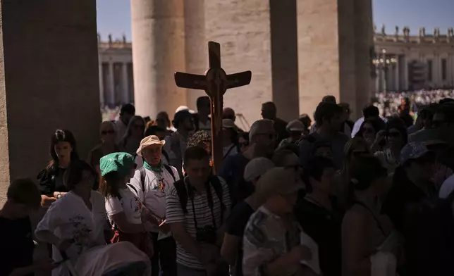 Pilgrims arrive to visit St. Peter's Basilica on the seventh of nine days of mourning for late Pope Francis, at the Vatican, Friday, May 2, 2025. (AP Photo/Francisco Seco)