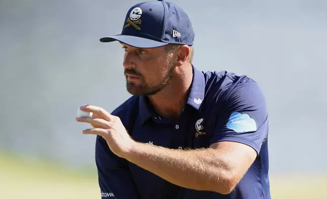 Bryson DeChambeau waves after making a putt on the 14th hole during the final round of the PGA Championship golf tournament at the Quail Hollow Club, Sunday, May 18, 2025, in Charlotte, N.C. (AP Photo/Matt York)