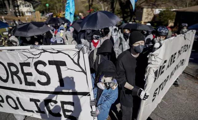 FILE - Protesters march during a demonstration in opposition to a new police training center on Nov. 13, 2023, in Atlanta. (AP Photo/Mike Stewart, File)