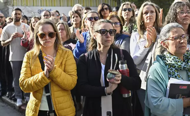 People watch the funeral procession of the late former President Jose Mujica from the presidential palace to the National Assembly in Montevideo, Uruguay, Wednesday, May 14, 2025. (AP Photo/Santiago Mazzarovich)
