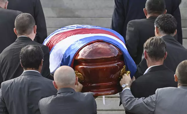 The casket of late former President Jose Mujica is carried into the Legislative Palace during funeral ceremonies in Montevideo, Uruguay, Wednesday, May 14, 2025. (AP Photo/Santiago Mazzarovich)