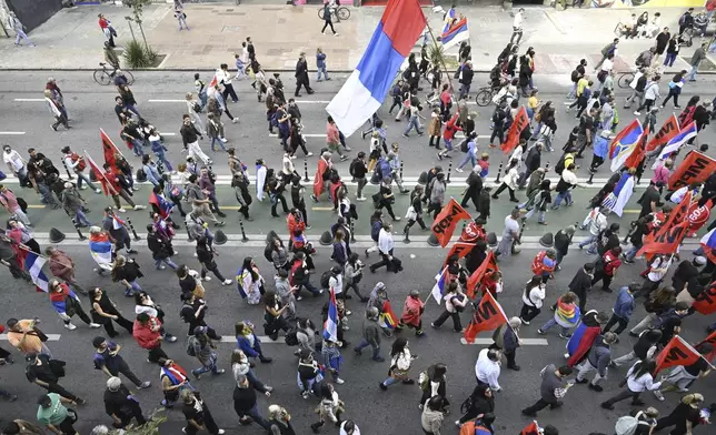 Supporters walk behind the casket of late former President Jose Mujica during his funeral procession from the presidential palace to the National Assembly in Montevideo, Uruguay, Wednesday, May 14, 2025. (AP Photo/Santiago Mazzarovich)