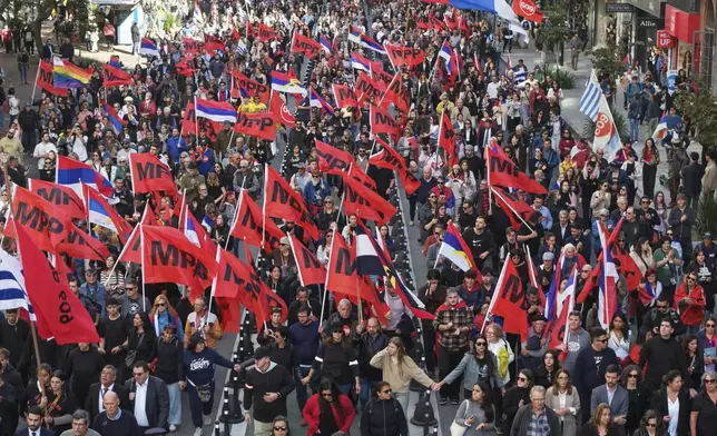 Supporters escort the casket of Uruguay's former President Jose Mujica from the presidential palace to the National Assembly during a funeral procession in Montevideo, Uruguay, Wednesday, May 14, 2025. (AP Photo/Santiago Mazzarovich)