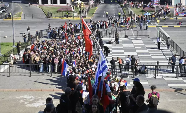 People line up to pay their final respects to the late former President Jose Mujica lying in state at the Legislative Palace, in Montevideo, Uruguay, Wednesday, May 14, 2025. (AP Photo/Santiago Mazzarovich)