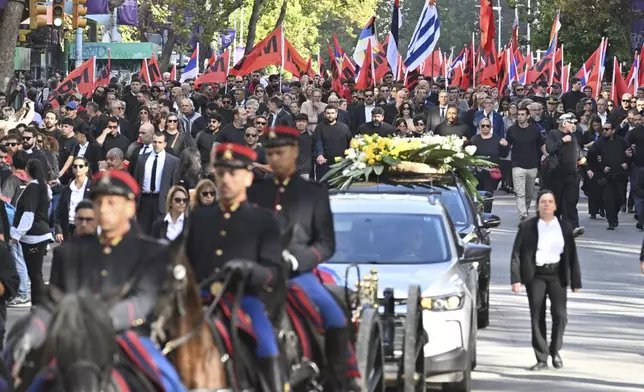 Supporters walk behind the casket of former President Jose Mujica during a funeral procession from the presidential palace to the National Assembly in Montevideo, Uruguay, Wednesday, May 14, 2025. (AP Photo/Santiago Mazzarovich)