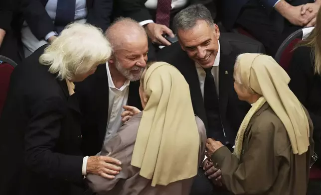 Lucia Topolansky, widow of late former Uruguayan President Jose Mujica, left, Brazil's President Luiz Inacio Lula Da Silva, center, and Uruguayan President Yamandu Orsi talk to nuns during funeral ceremonies for the late leader at the Legislative Palace in Montevideo, Uruguay, Thursday, May 15, 2025. (AP Photo/Matilde Campodonico)