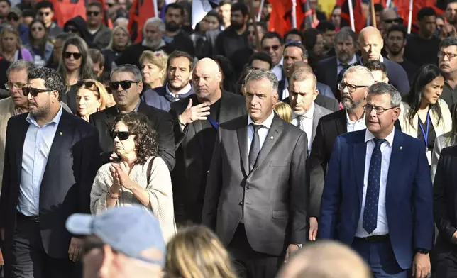 Uruguayan President Yamandu Orsi, second from right, front, leads the funeral procession for late former President Jose Mujica in Montevideo, Uruguay, Wednesday, May 14, 2025. (AP Photo/Santiago Mazzarovich)