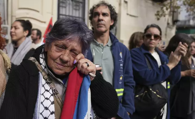 Mourners watch the casket of Uruguay's former President Jose Mujica during his funeral procession from the presidential palace to the National Assembly in Montevideo, Uruguay, Wednesday, May 14, 2025. (AP Photo/Matilde Campodonico)
