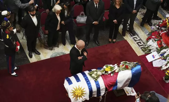 Brazil's President Luiz Inacio Lula Da Silva stands beside the casket of former Uruguayan President Jose Mujica during the late leader's funeral ceremonies at the Legislative Palace in Montevideo, Uruguay, Thursday, May 15, 2025. (AP Photo/Matilde Campodonico)