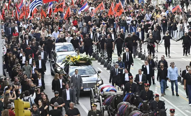 Supporters walk behind the casket of Uruguay's former President Jose Mujica during his funeral procession from the presidential palace to the National Assembly in Montevideo, Uruguay, Wednesday, May 14, 2025. (AP Photo/Santiago Mazzarovich)