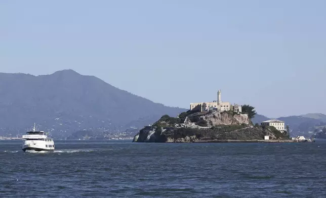 A tour boat is skippered past Alcatraz Island Monday, May 5, 2025, in San Francisco. (AP Photo/Jed Jacobsohn)