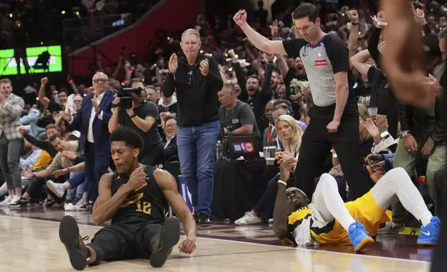 Cleveland Cavaliers forward De'Andre Hunter, left, celebrates after hitting a three-point shot and drawing a foul on Indiana Pacers forward Pascal Siakam, right, during the second half in Game 5 of an Eastern Conference semifinal NBA basketball playoff Tuesday, May 13, 2025, in Cleveland. (AP Photo/Sue Ogrocki)