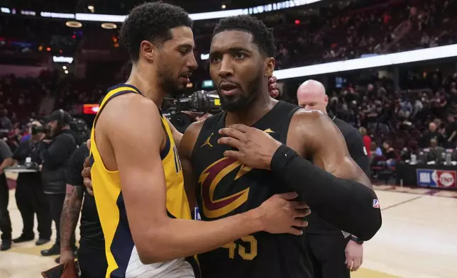 Indiana Pacers guard Tyrese Haliburton, left, and Cleveland Cavaliers guard Donovan Mitchell greet each other after the Pacers defeated the Cleveland Cavaliers 114-105 in Game 5 of an Eastern Conference semifinal NBA basketball playoff Tuesday, May 13, 2025, in Cleveland. (AP Photo/Sue Ogrocki)