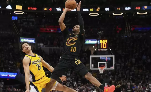 Cleveland Cavaliers guard Darius Garland, right, shoots as Indiana Pacers guard Ben Sheppard defends during the second half in Game 5 of an Eastern Conference semifinal NBA basketball playoff Tuesday, May 13, 2025, in Cleveland. (AP Photo/Sue Ogrocki)