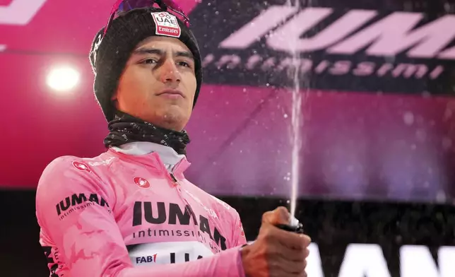 Mexico's Isaac Del Toro Romero of UAE Team Emirates Xrg reacts with the leader’s pink jersey after the 10th stage of the Giro d'Italia cycling race, an individual time trial from Lucca to Pisa, Italy, Tuesday, May 20, 2025. (Gian Mattia D'Alberto/LaPresse via AP)
