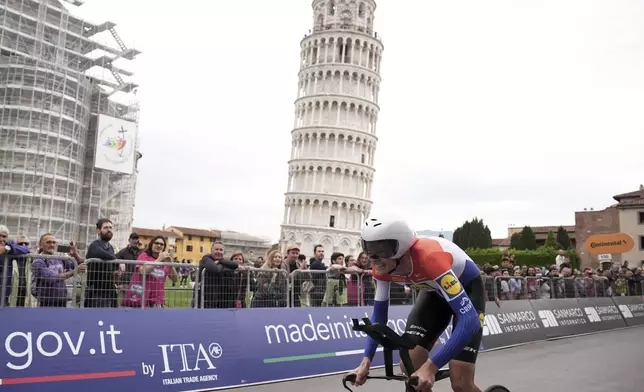 Dutch rider Daan Hoole pedals past the Pisa's leaning Tower during the 10th stage of the Giro d'Italia cycling race, an individual time trial from Lucca to Pisa, Italy, Tuesday, May 20, 2025. (Marco Alpozzi/LaPresse via AP)