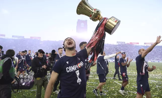 The Bologna team celebrates with the Italian Cup won last week at the end of the Serie A soccer match between Bologna and Genoa, at the Renato Dall'Ara Stadium, in Bologna, Italy, Saturday, May 24, 2025. (Michele Nucci/LaPresse via AP)