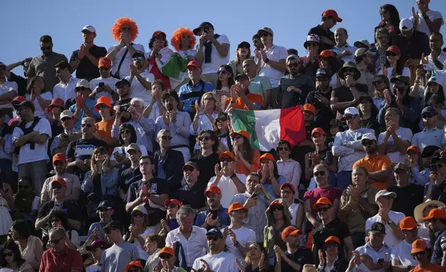 Italian fans cheer for Jannik Sinner during a final tennis match against Carlos Alcaraz of Spain in the Italian Open at the Foro Italico in Rome, Sunday, May 18, 2025. (AP Photo/Alessandra Tarantino)