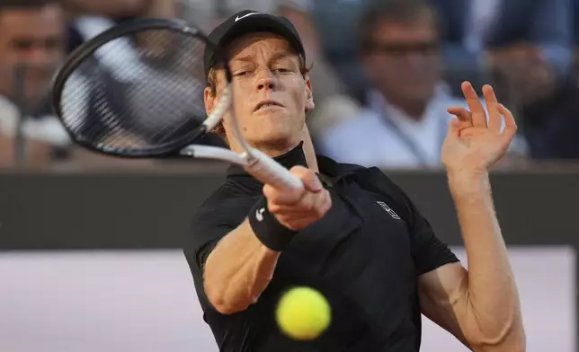 Jannik Sinner of Italy, returns to Carlos Alcaraz of Spain during their final tennis match in the Italian Open at the Foro Italico in Rome, Sunday, May 18, 2025. (AP Photo/Alessandra Tarantino)