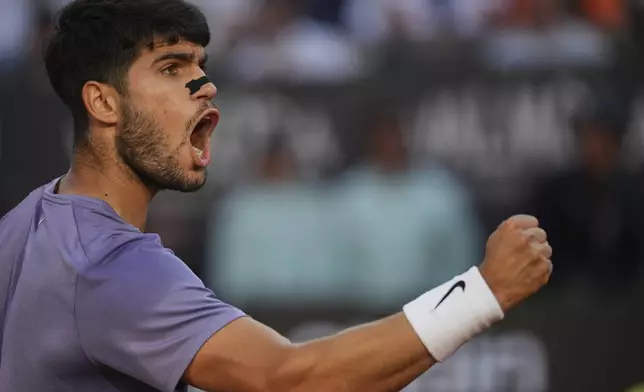 Carlos Alcaraz of Spain, reacts after scoring a point against Jannik Sinner of Italy during their final tennis match in the Italian Open at the Foro Italico in Rome, Sunday, May 18, 2025. (AP Photo/Alessandra Tarantino)