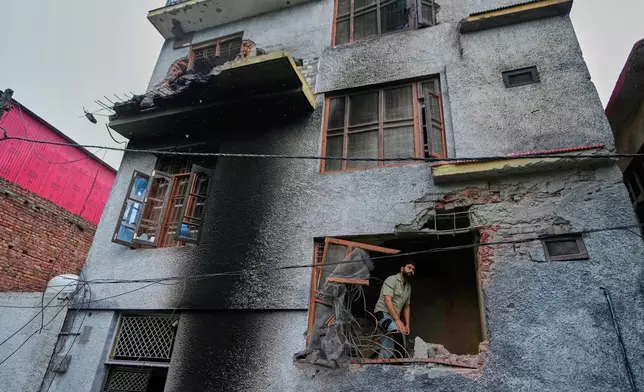 A resident inspects his house damaged by Pakistani artillery shelling in Poonch, along the Line of Control, Indian controlled Kashmir, Thursday, May 8, 2025. (AP Photo/Channi Anand)