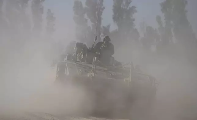 Israeli troops move along the border with Gaza, in southern Israel, Thursday, May 8, 2025. (AP Photo/Ariel Schalit)