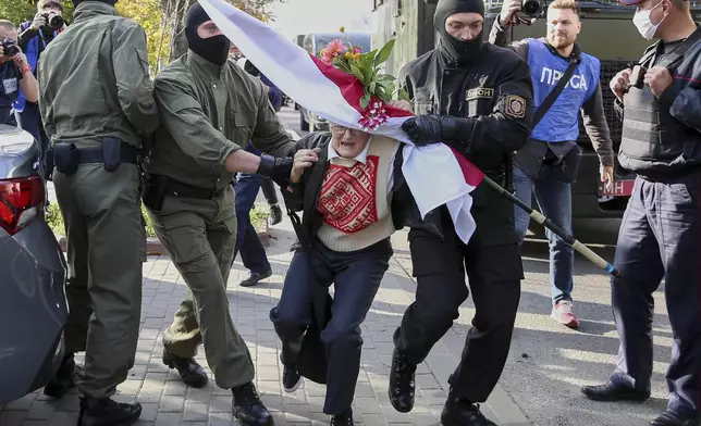 FILE - Police officers detain Nina Bahinskaya, 73, during an opposition rally to protest the official presidential election results in Minsk, Belarus, Saturday, Sept. 19, 2020. (AP Photo/TUT.by, File)