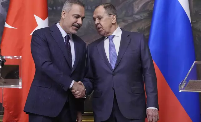 Russian Foreign Minister Sergey Lavrov, right, and Turkish Foreign Minister Hakan Fidan shake hands during their meeting in Moscow, Russia, Tuesday, May 27, 2025. (AP Photo/Pavel Bednyakov, Pool)