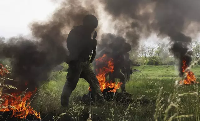 In this photo provided by Ukraine's 65th Mechanized Brigade press service, Ukrainian servicemen attend a military training in Zaporizhzhia region, Ukraine, Monday, May 26, 2025. (Andriy Andriyenko/Ukraine's 65th Mechanized Brigade via AP)