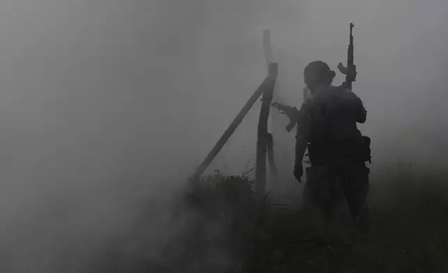 In this photo provided by Ukraine's 65th Mechanized Brigade press service, Ukrainian servicemen attend a military training in Zaporizhzhia region, Ukraine, Monday, May 26, 2025. (Andriy Andriyenko/Ukraine's 65th Mechanized Brigade via AP)
