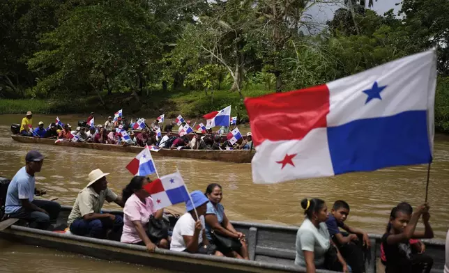 Demonstrators travel by river to the mouth of the Rio Indio on Panama's Caribbean coast to protest a planned reservoir for the Panama Cana on Friday, May 16, 2025. (AP Photo/Matias Delacroix)