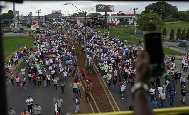 Anti-government protesters march against a law, which overhauls the social security agency, and the recently signed Panama-U.S. memorandum concerning the Panama Canal, in Santiago, Panama, Tuesday, May 13, 2025. (AP Photo/Matias Delacroix)