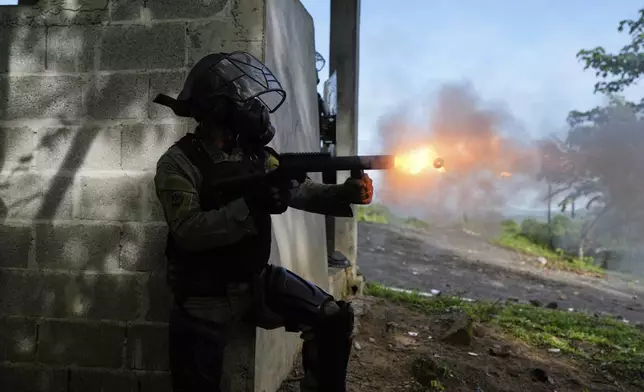 Police fire tear gas to break up a blockade on the Pan-American Highway set up by anti-government protesters opposing social security reforms and a Panama-U.S. memorandum concerning the Panama Canal, in El Piro, Panama, Wednesday, May 14, 2025. (AP Photo/Matias Delacroix)