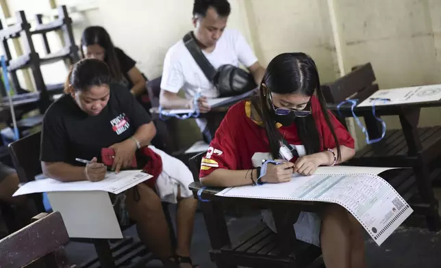 Voters cast their ballots at a polling station in Quezon City, Philippines, Monday, May 12, 2025. (AP Photo/Basilio Sepe)