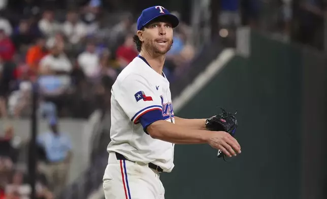 Texas Rangers starting pitcher Jacob deGrom watches a hit ball go foul during the seventh inning of a baseball game against the Houston Astros, Thursday, May 15, 2025, in Arlington, Texas. (AP Photo/LM Otero)