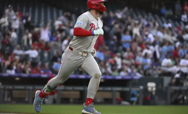 Philadelphia Phillies' Bryce Harper (3) runs the bases on a home run in the third inning of a baseball game against the Colorado Rockies Wednesday, May 21, 2025, in Denver. (AP Photo/Geneva Heffernan)