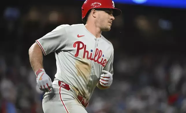 Philadelphia Phillies' J.T. Realmuto (10) runs the bases on a two-run home run in the sixth inning of a baseball game against the Colorado Rockies Wednesday, May 21, 2025, in Denver. (AP Photo/Geneva Heffernan)