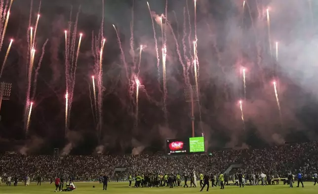 Firework explode as Lahore Qalandars' players and officials celebrates after winning the Pakistan Super League Twenty20 final cricket match against Quetta Gladiators, in Lahore, Pakistan, Sunday, May 25, 2025. (AP Photo/K.M. Chaudary)