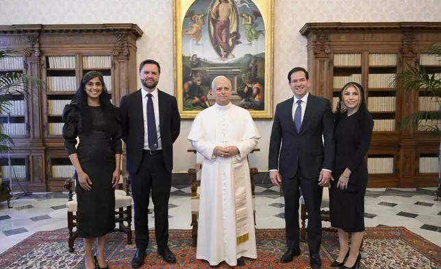 Pope Leo XIV stands for a family photo with Vice President JD Vance, second from left, his wife Usha Vance, Secretary of State Marco Rubio, second from right, and his wife Jeanette Dousdebes Rubio, on the occasion of their meeting at the Vatican, Monday, May 19, 2025. (Vatican Media via AP)