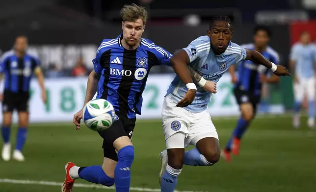 New York City FC's Andres Perea, right, fights for the ball with CF Montreal's Dawid Bugaj, left, during an MLS soccer match Saturday, May 10, 2025, in New York. (AP Photo/Andres Kudacki)