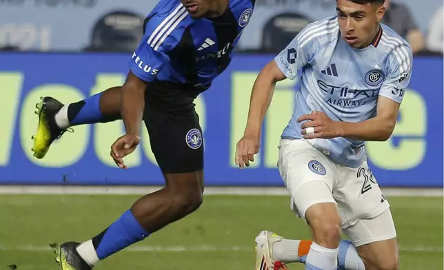 New York City FC's Agustin Ojeda, right, fights for the ball with CF Montreal's Dante Sealy, left, during an MLS soccer match Saturday, May 10, 2025, in New York. (AP Photo/Andres Kudacki)
